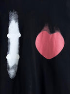 Balenciaga long-sleeve top front close-up: white candle and pink heart graphic