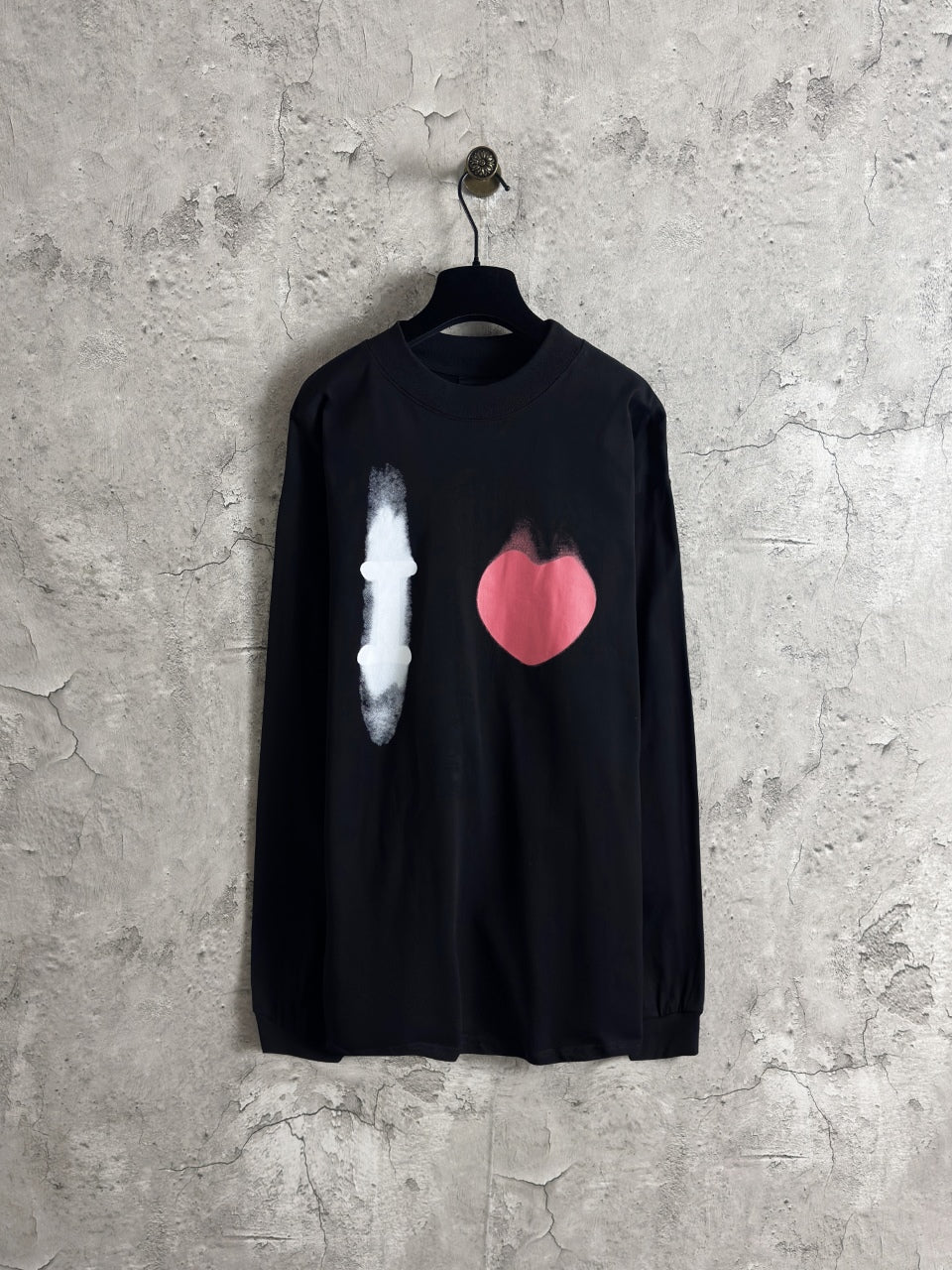 Balenciaga long-sleeve top, dark with white candle and pink heart graphic on front