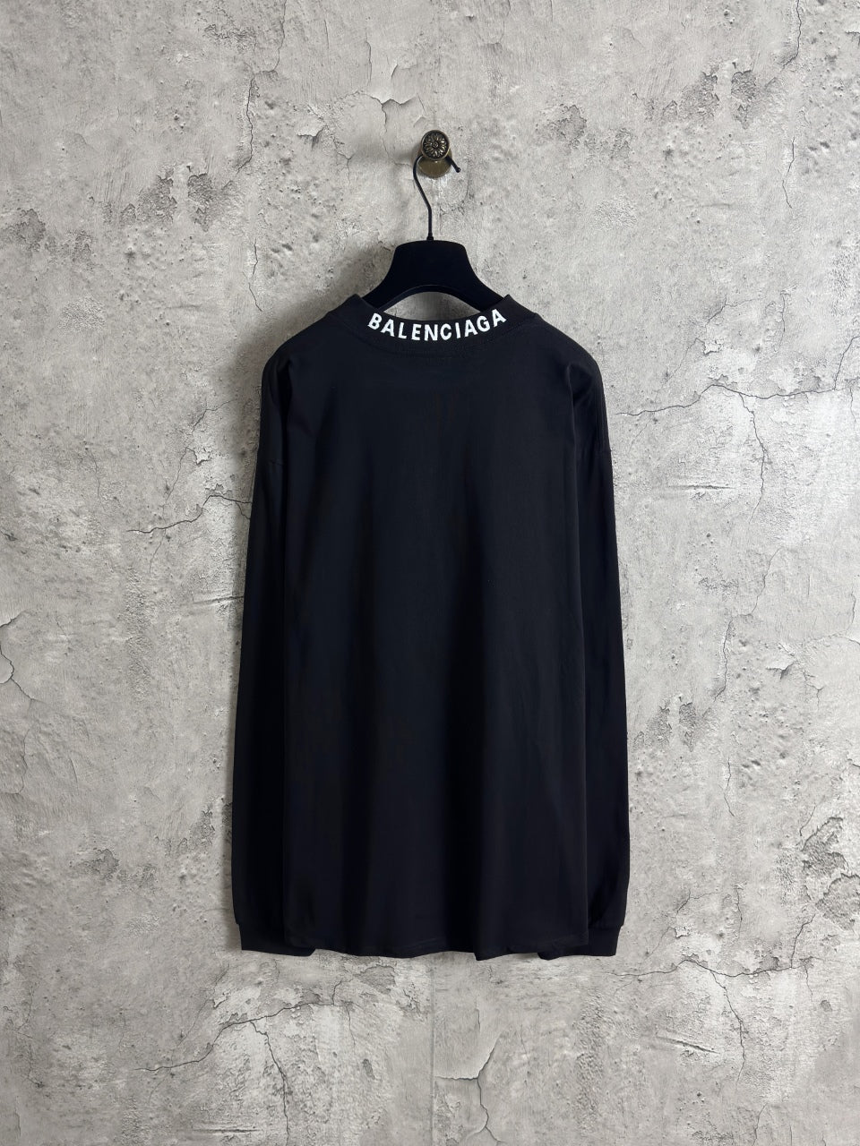 Balenciaga long-sleeve top, dark; back view with BALENCIAGA logo across neckline