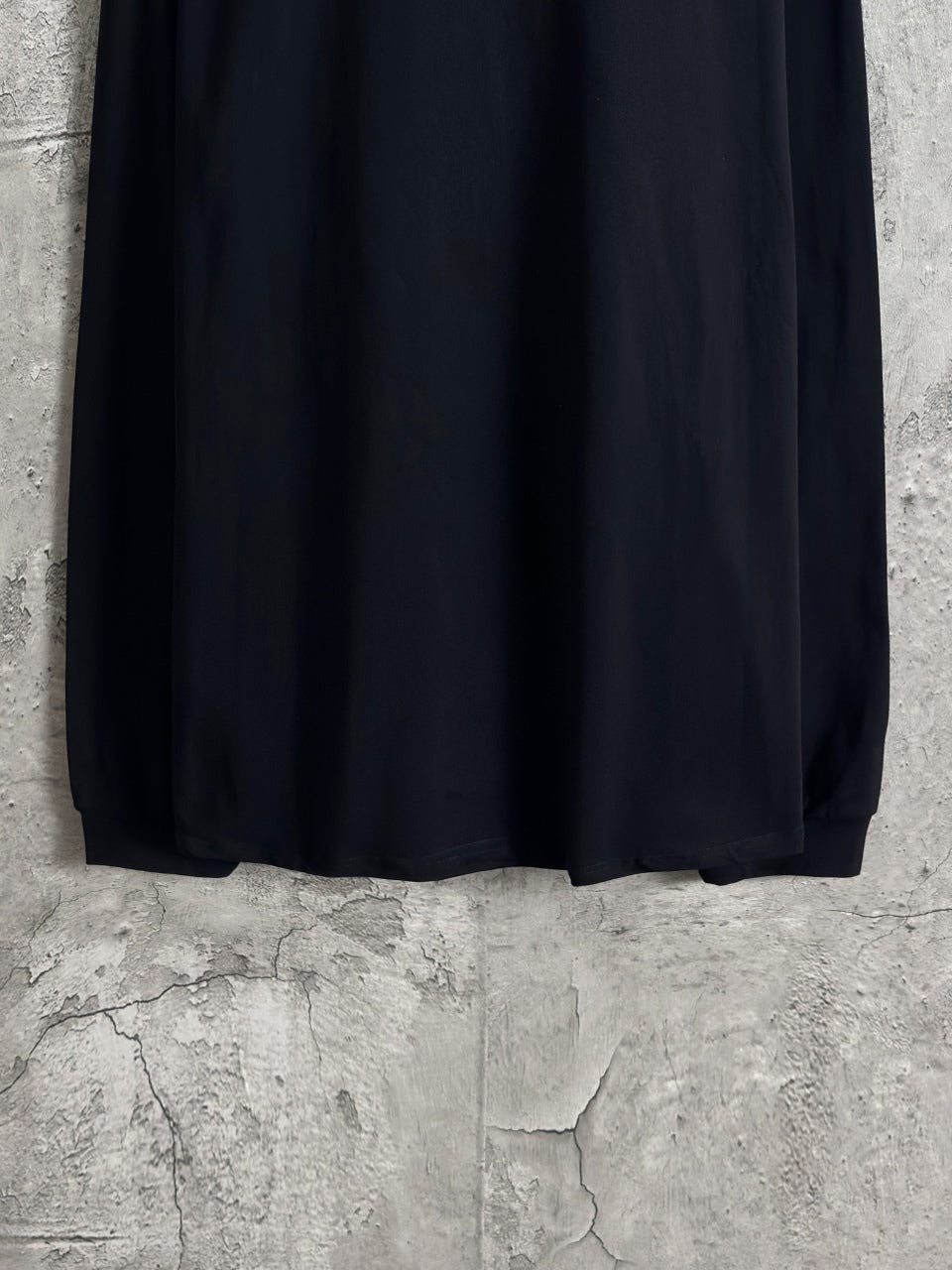 Balenciaga long-sleeve top full back view, dark fabric with straight hem