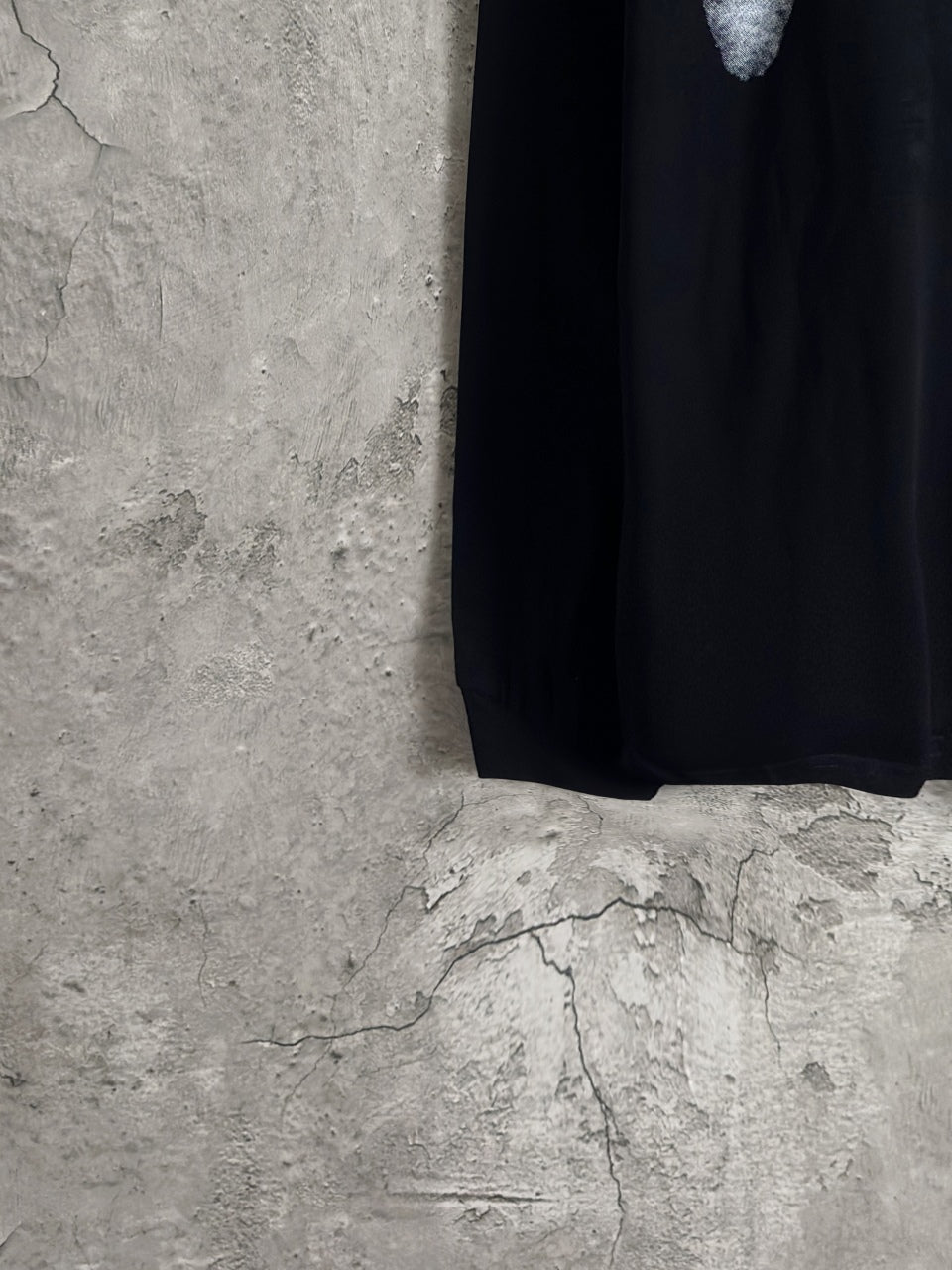 Balenciaga long-sleeve top hem and side view in dark fabric