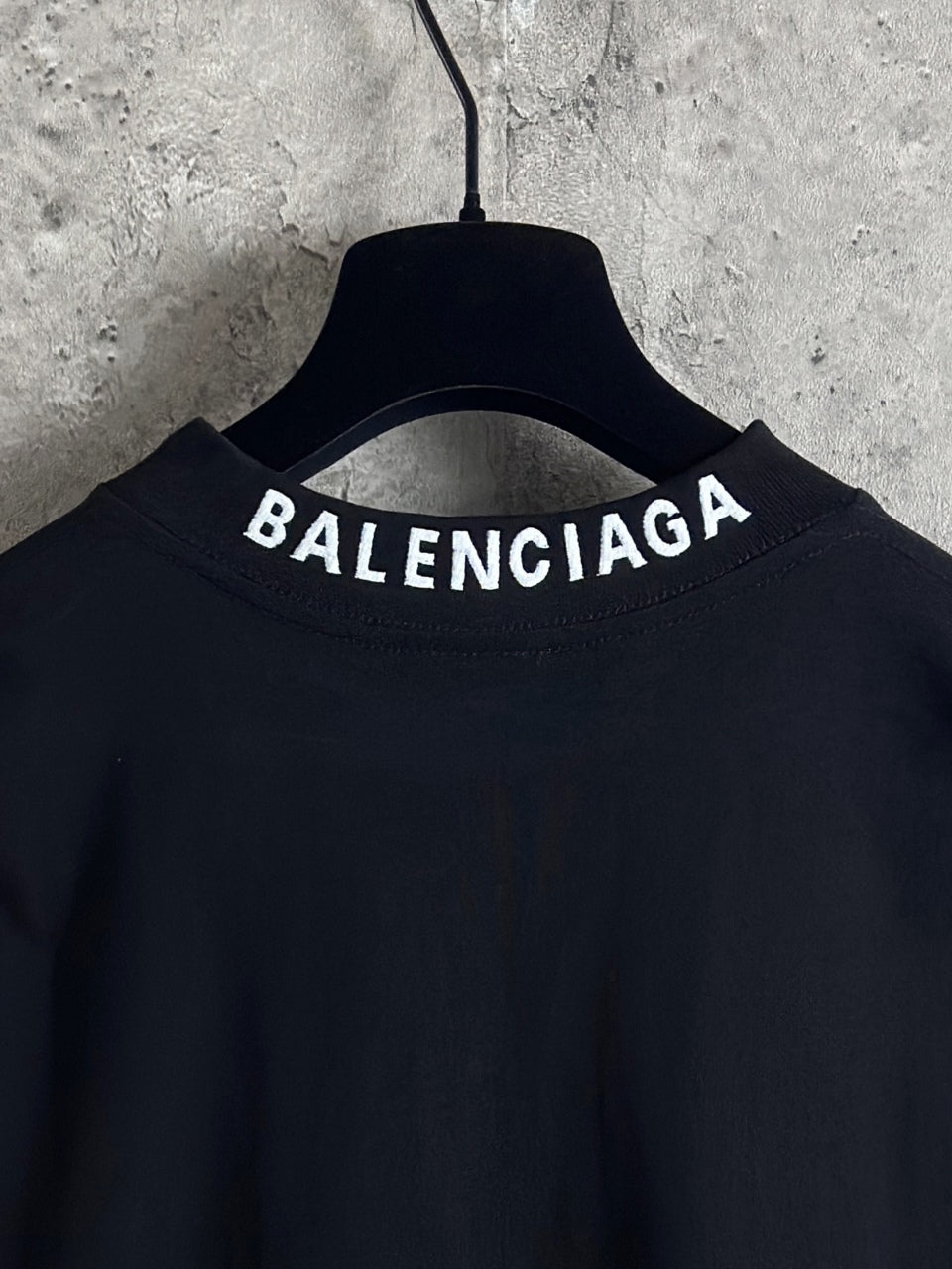 Balenciaga long-sleeve top back neckline close-up with BALENCIAGA lettering