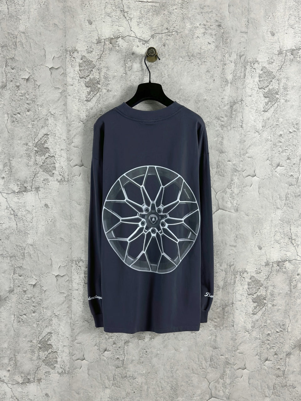 Dark blue long-sleeve crewneck T-shirt with large white wheel graphic on front.