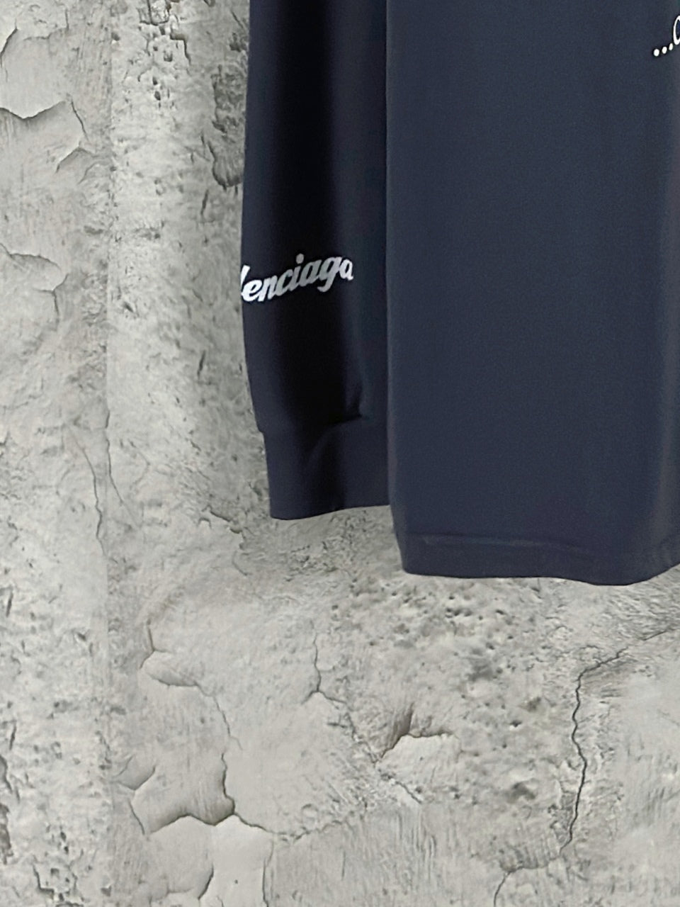 Dark blue long-sleeve T-shirt sleeve end with small white Lamborghini text.