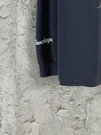 Dark blue long-sleeve T-shirt sleeve end with small white Lamborghini text.