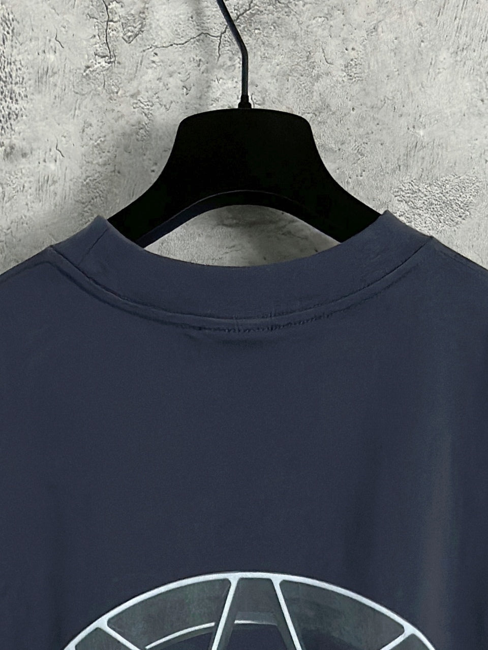 Navy long-sleeve crewneck T-shirt collar with wheel hub graphic, top view
