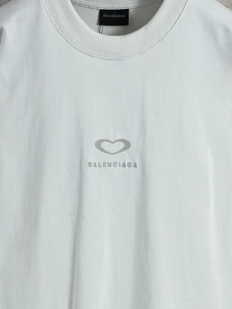 White Balenciaga crewneck T-shirt close-up of heart and BALENCIAGA logo