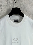White Balenciaga crewneck T-shirt neckline with small heart logo on chest