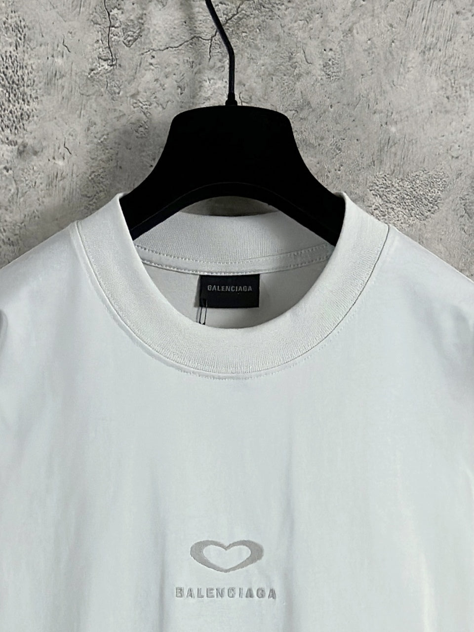 White Balenciaga crewneck T-shirt neckline with small heart logo on chest