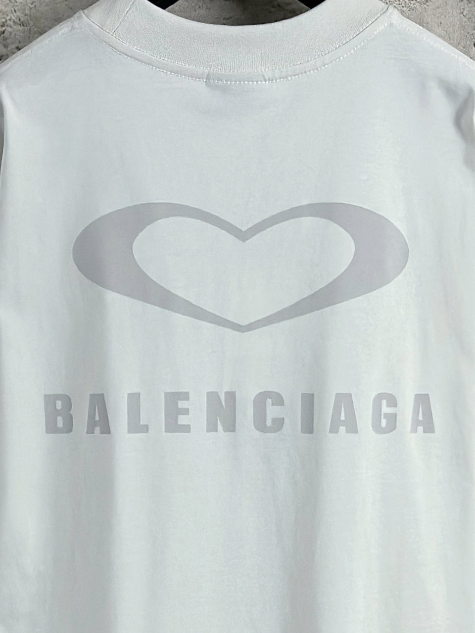 White Balenciaga crewneck T-shirt close-up of heart graphic and BALENCIAGA text