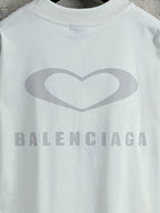 White Balenciaga crewneck T-shirt close-up of heart graphic and BALENCIAGA text