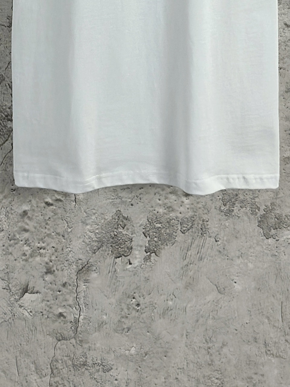 White Balenciaga short-sleeve T-shirt bottom hem view with straight hemline