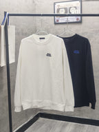White long-sleeve crewneck sweatshirt with small blue chest logo