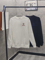 White and dark navy long-sleeve sweatshirts on hangers