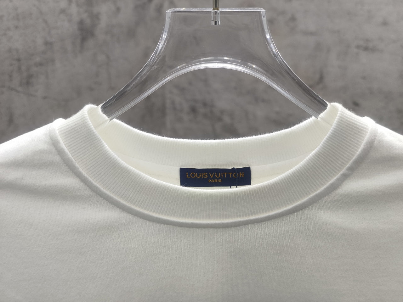 White long-sleeve sweatshirt collar with Louis Vuitton neck label
