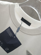 White crew-neck T-shirt with attached hang tags and woven neck label