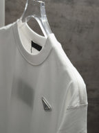 White short-sleeve T-shirt on clear hanger with triangular chest logo