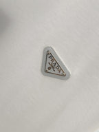 White T-shirt with silver-toned triangular PRADA logo patch