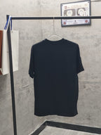 Dark short-sleeve T-shirt back view on hanger