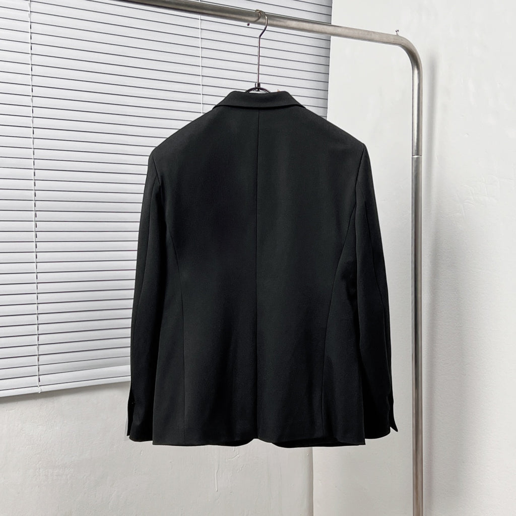 Black Dior suit jacket from the back, centered with shoulder seams and smooth hem