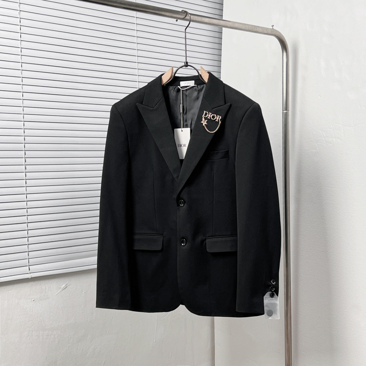 Black Dior suit jacket with notched lapels and two front flap pockets