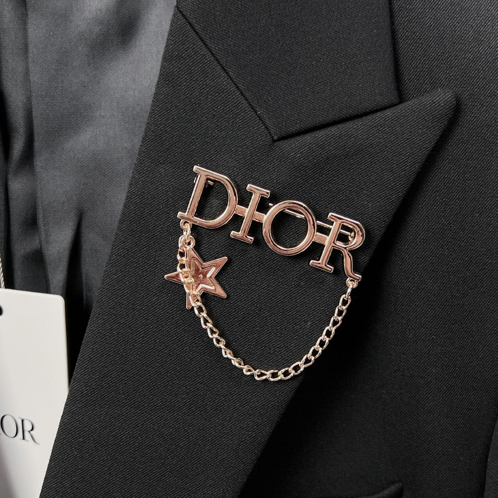 Dior logo and star chain detail on black suit lapel