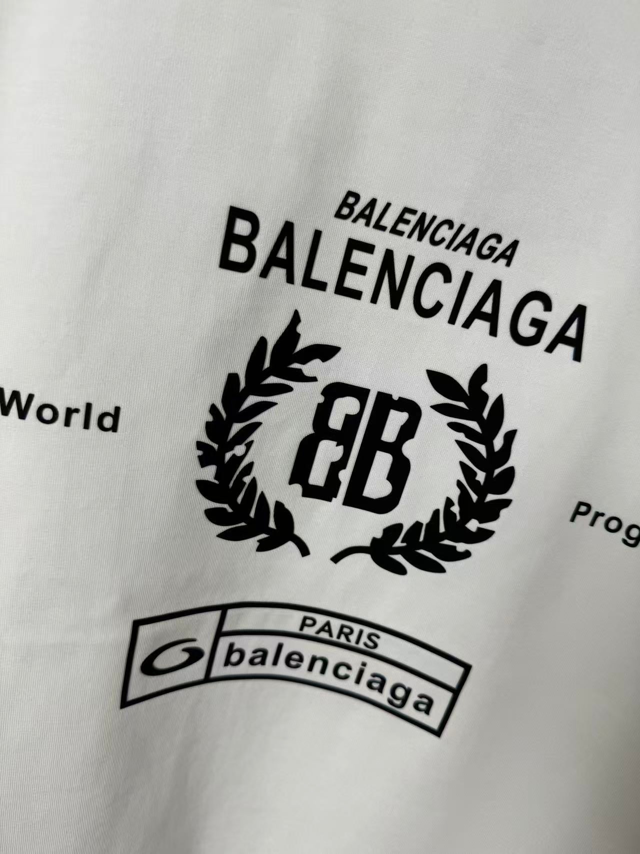 White Balenciaga T-shirt chest graphic with BALENCIAGA text and laurel EB logo