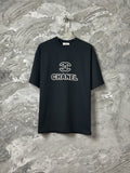 Black short-sleeve T-shirt with CHANEL logo graphic at center