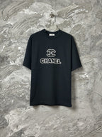 Black short-sleeve T-shirt with CHANEL logo graphic at center