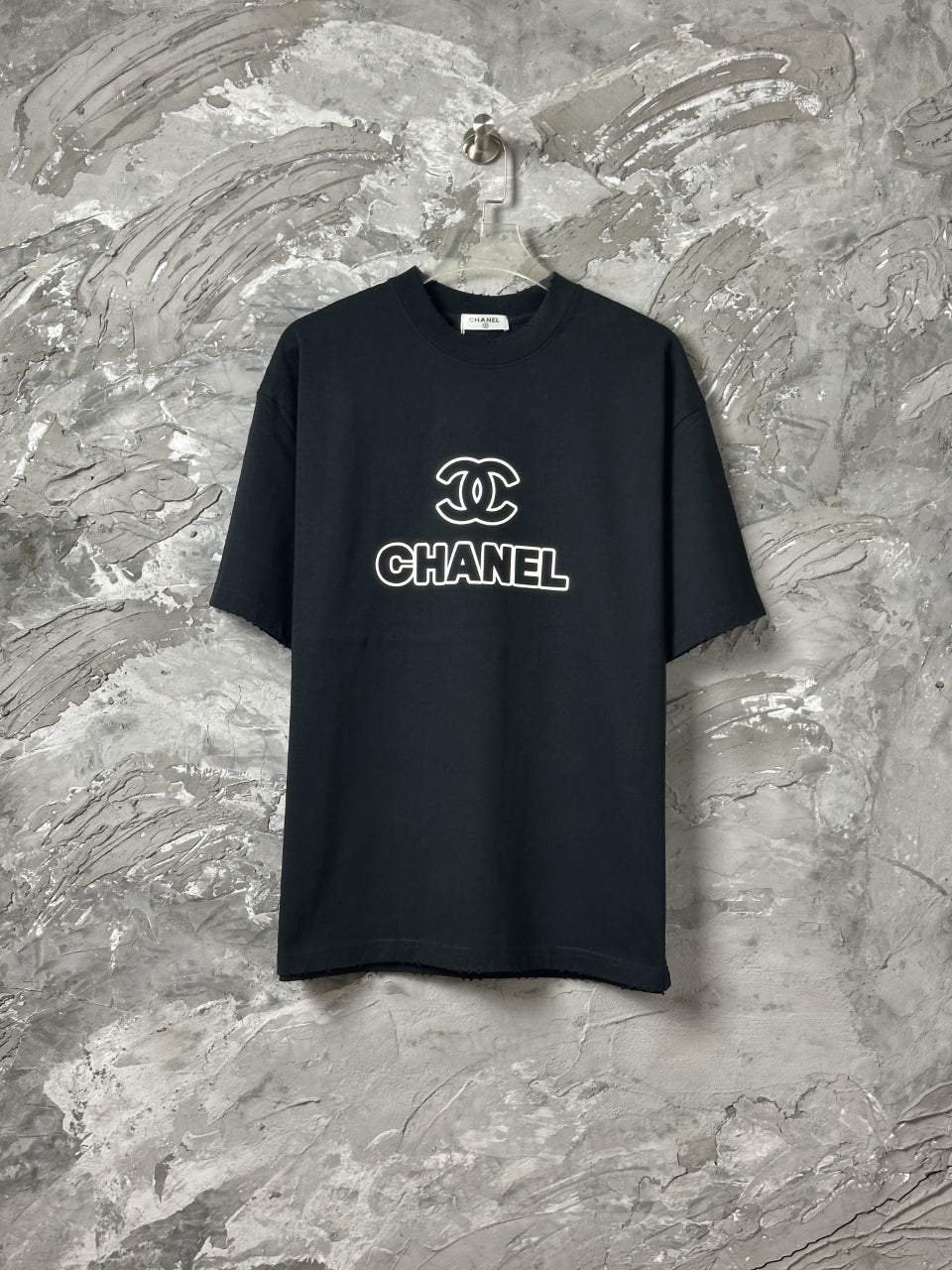 Black short-sleeve T-shirt with CHANEL logo graphic at center