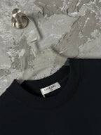 Black crew-neck T-shirt with CHANEL label at collar