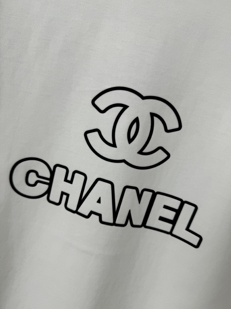 White T-shirt with CHANEL interlocking C and CHANEL text graphic