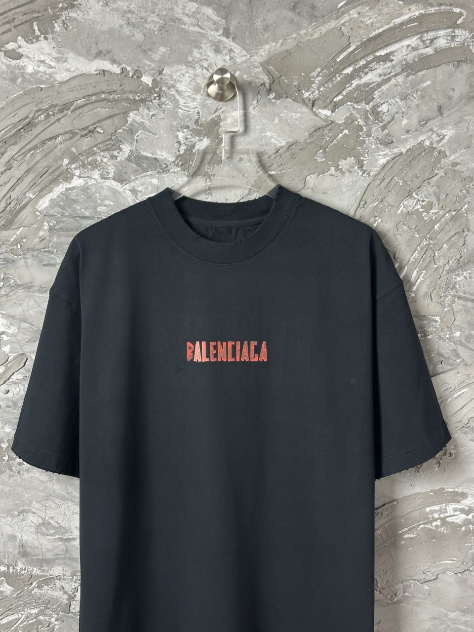 Black short-sleeve T-shirt with small red BALENCIAGA logo on chest