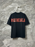 Black short-sleeve T-shirt with large red BALENCIAGA logo on back