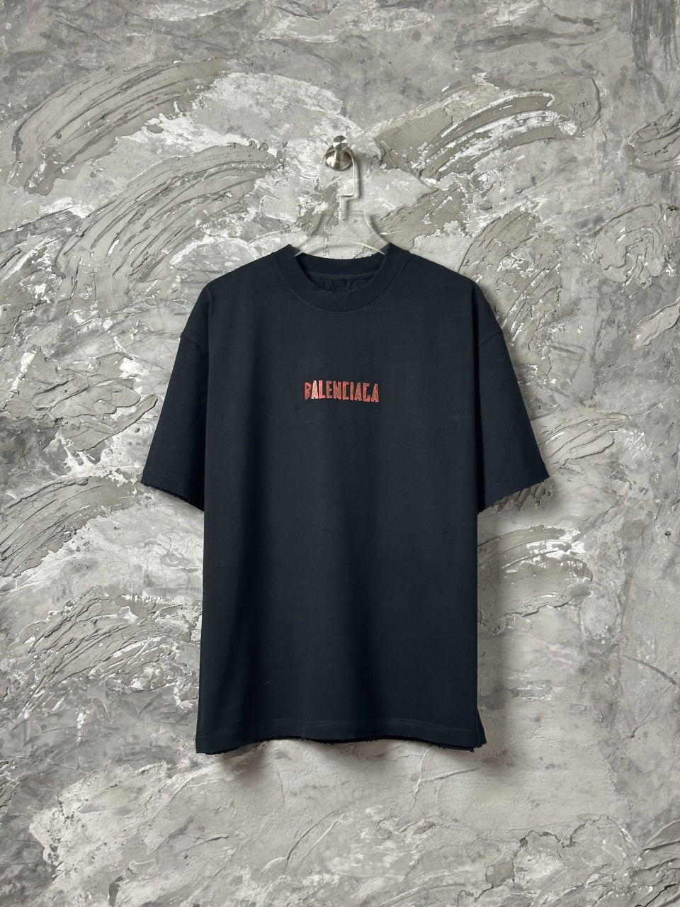 Black short-sleeve T-shirt with red BALENCIAGA logo on front