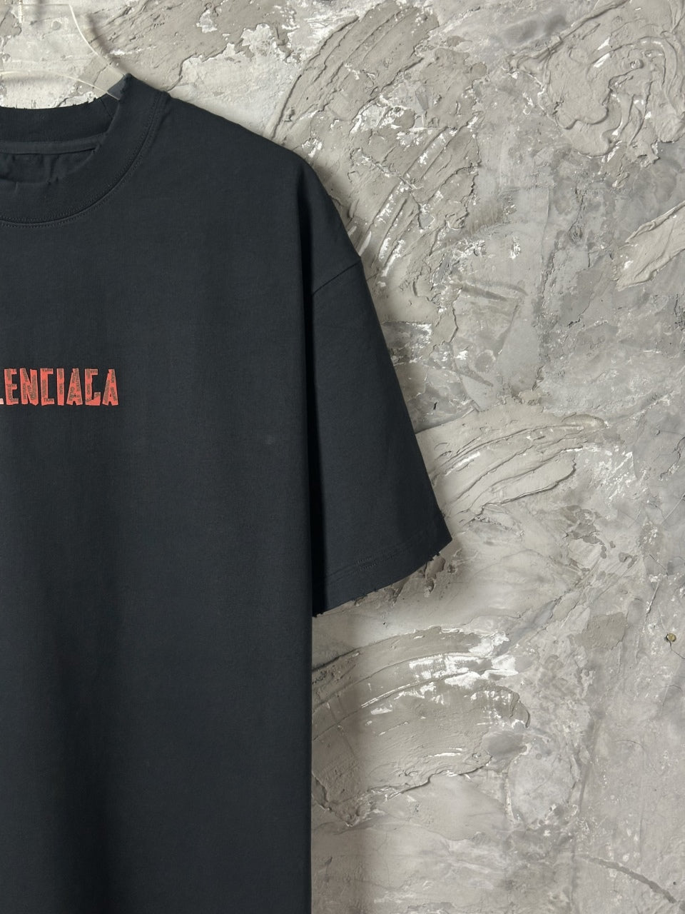 Black short-sleeve T-shirt with partial red BALENCIAGA text print
