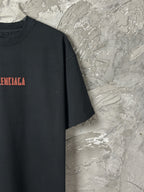 Black short-sleeve T-shirt with partial red BALENCIAGA text print