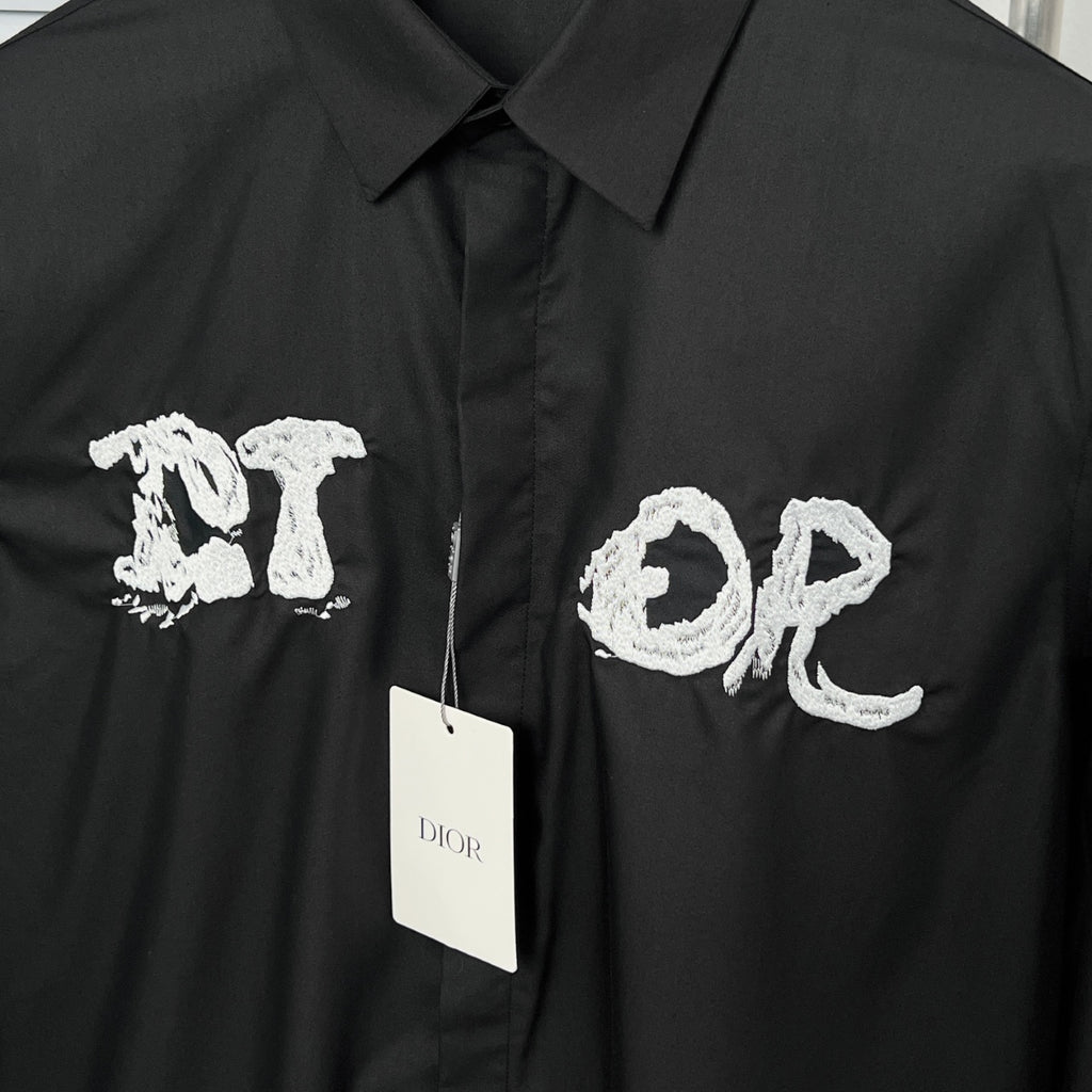 Dior long-sleeve shirt front with embroidered white letters and brand tag