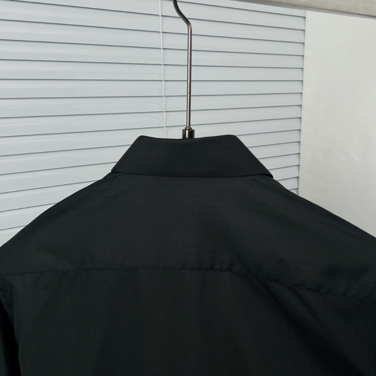 Dior long-sleeve shirt back yoke, black on a hanger
