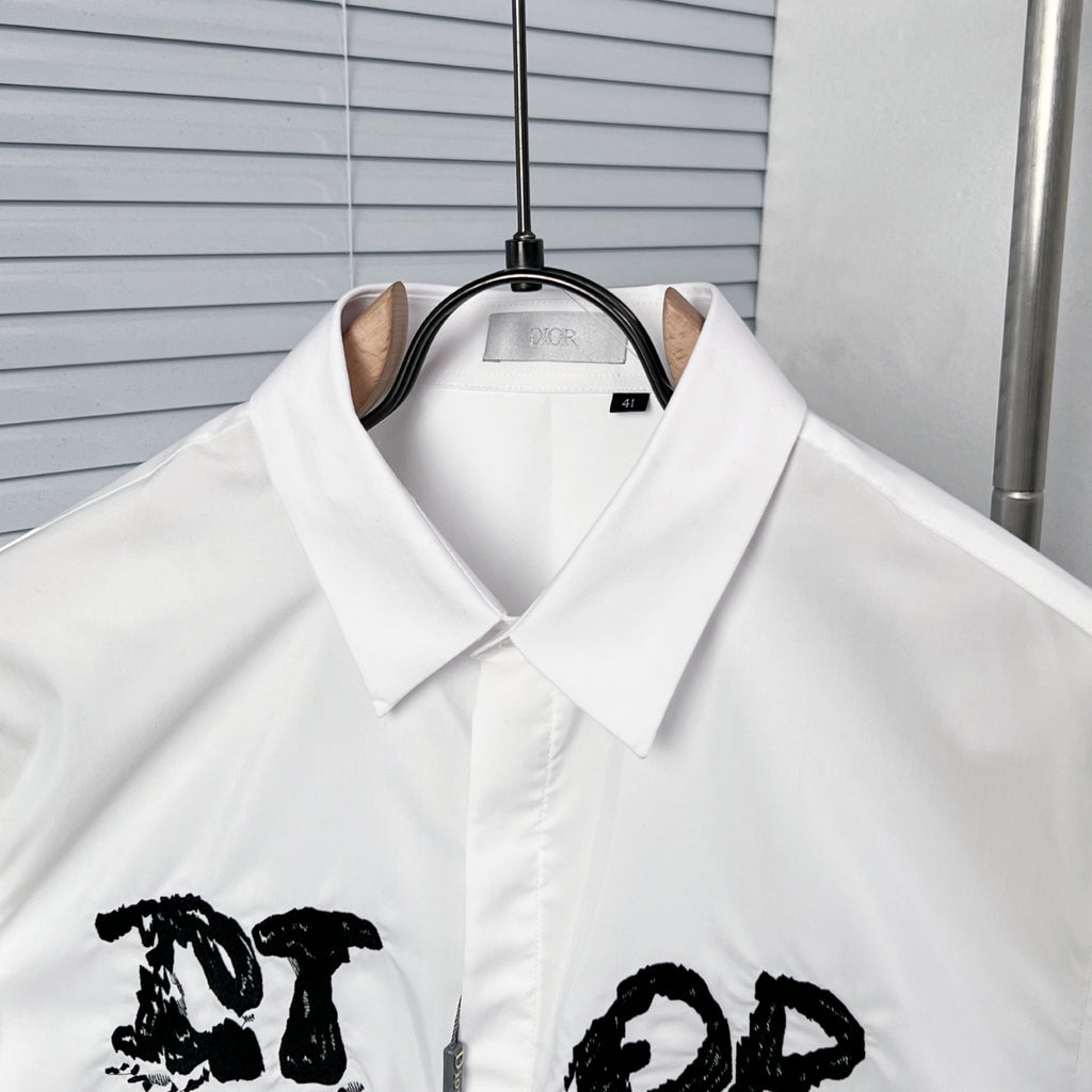 White button-up dress shirt collar with black graphic logo detail
