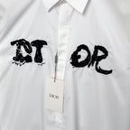 White button-up dress shirt front with black graphic logo and Dior tag