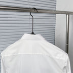 White button-up dress shirt back view on hanger