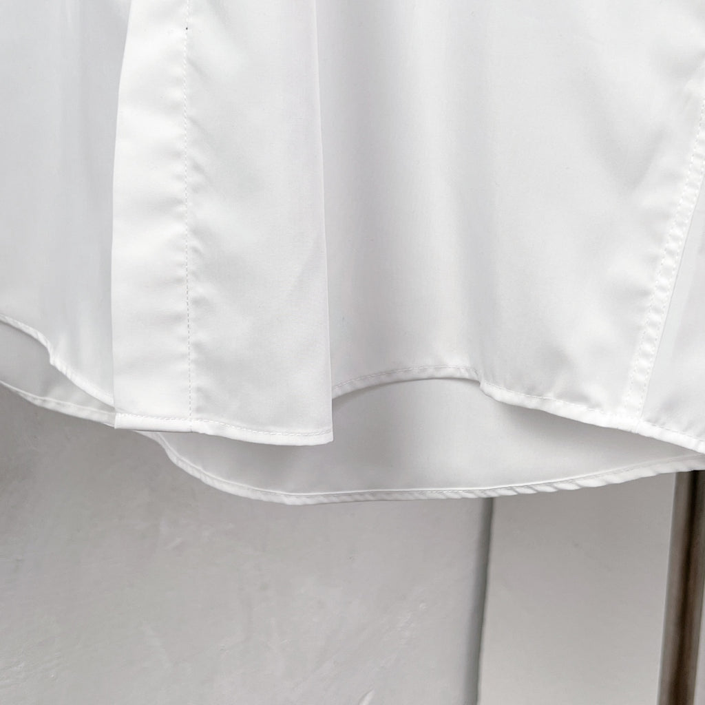 White button-up dress shirt hem and curved bottom edge