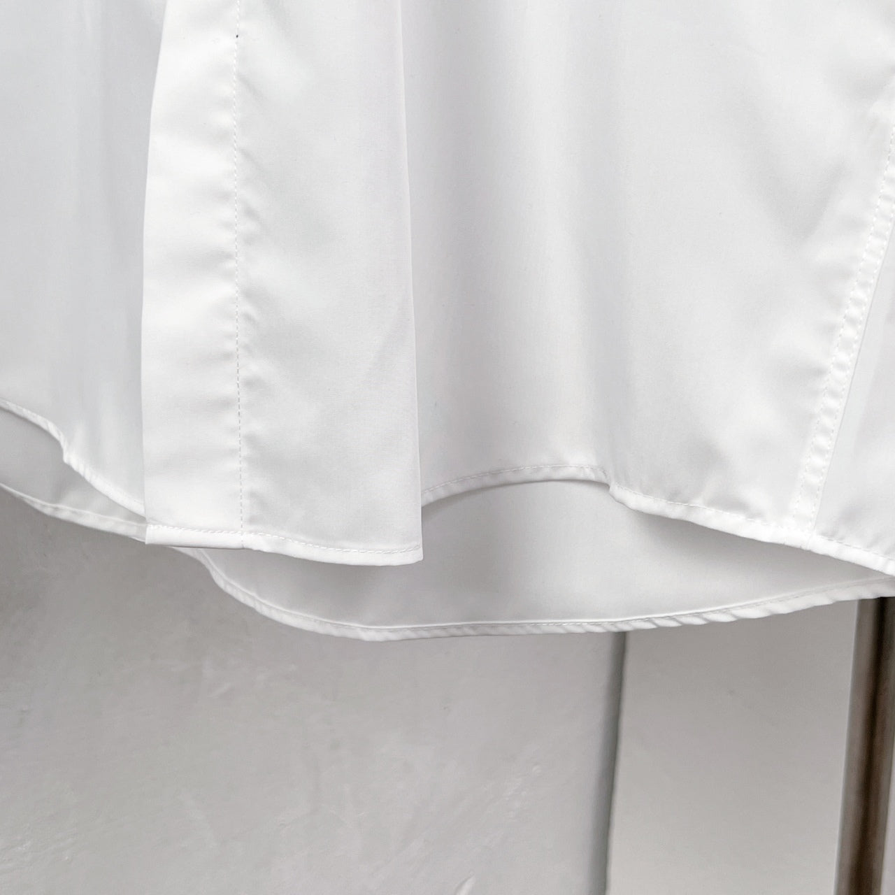 White button-up dress shirt hem and curved bottom edge