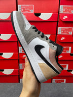 Low-top sneakers, angled side view in gray and white with black swoosh