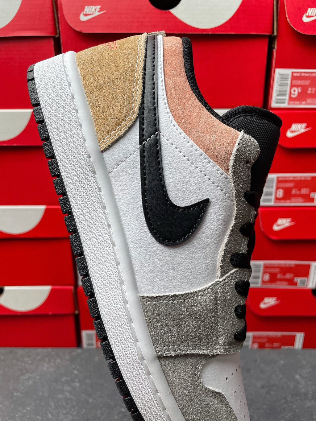 Low-top sneakers, close-up side view with white leather and black swoosh panel