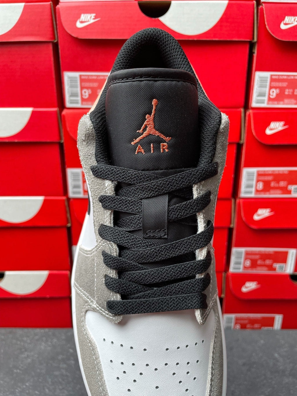 Low-top sneakers, tongue and collar view with Air Jordan logo and black laces