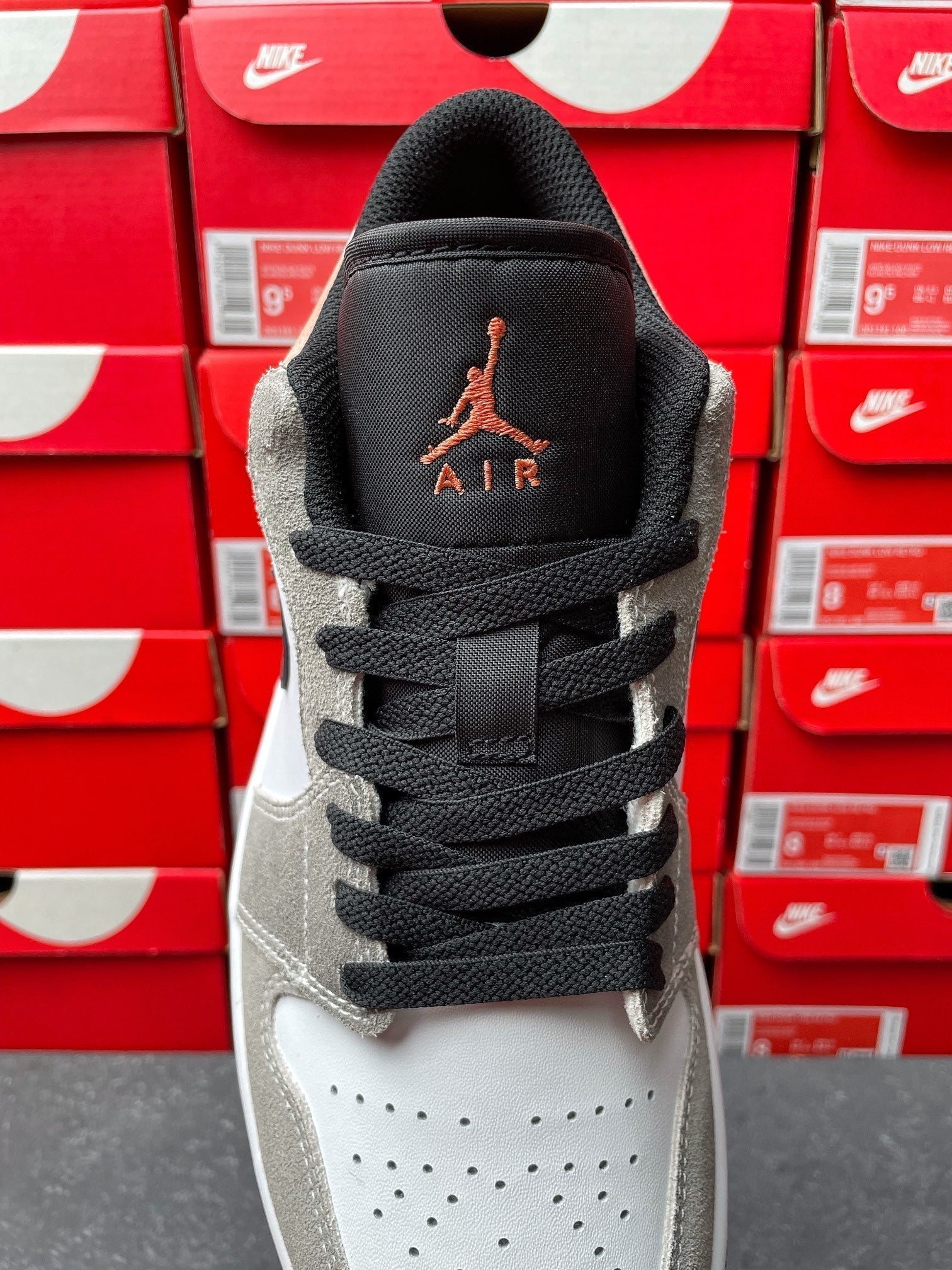 Low-top sneakers, tongue and collar view with Air Jordan logo and black laces