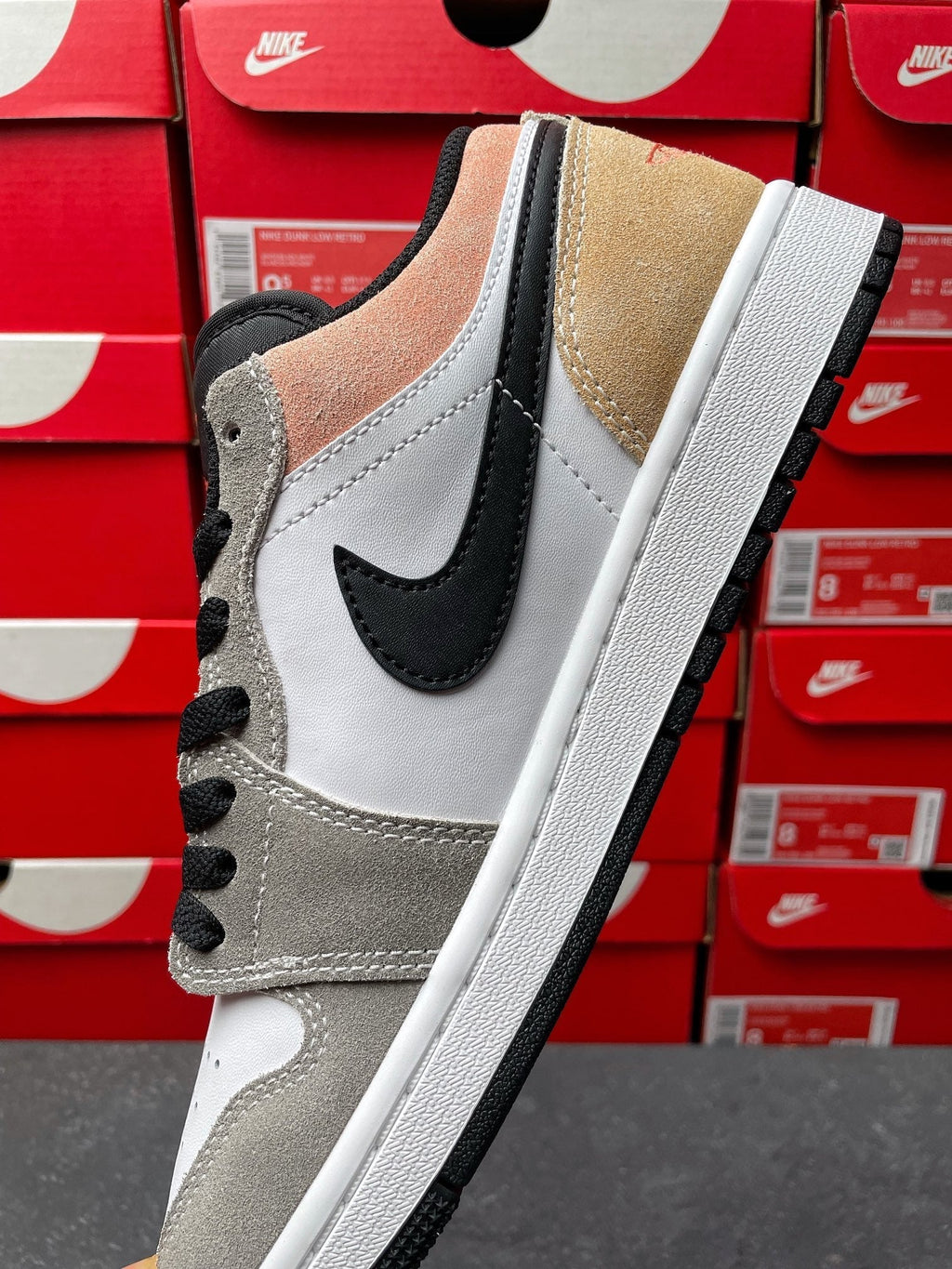 Low-top sneakers, toe and side view in white, gray, tan suede with black swoosh