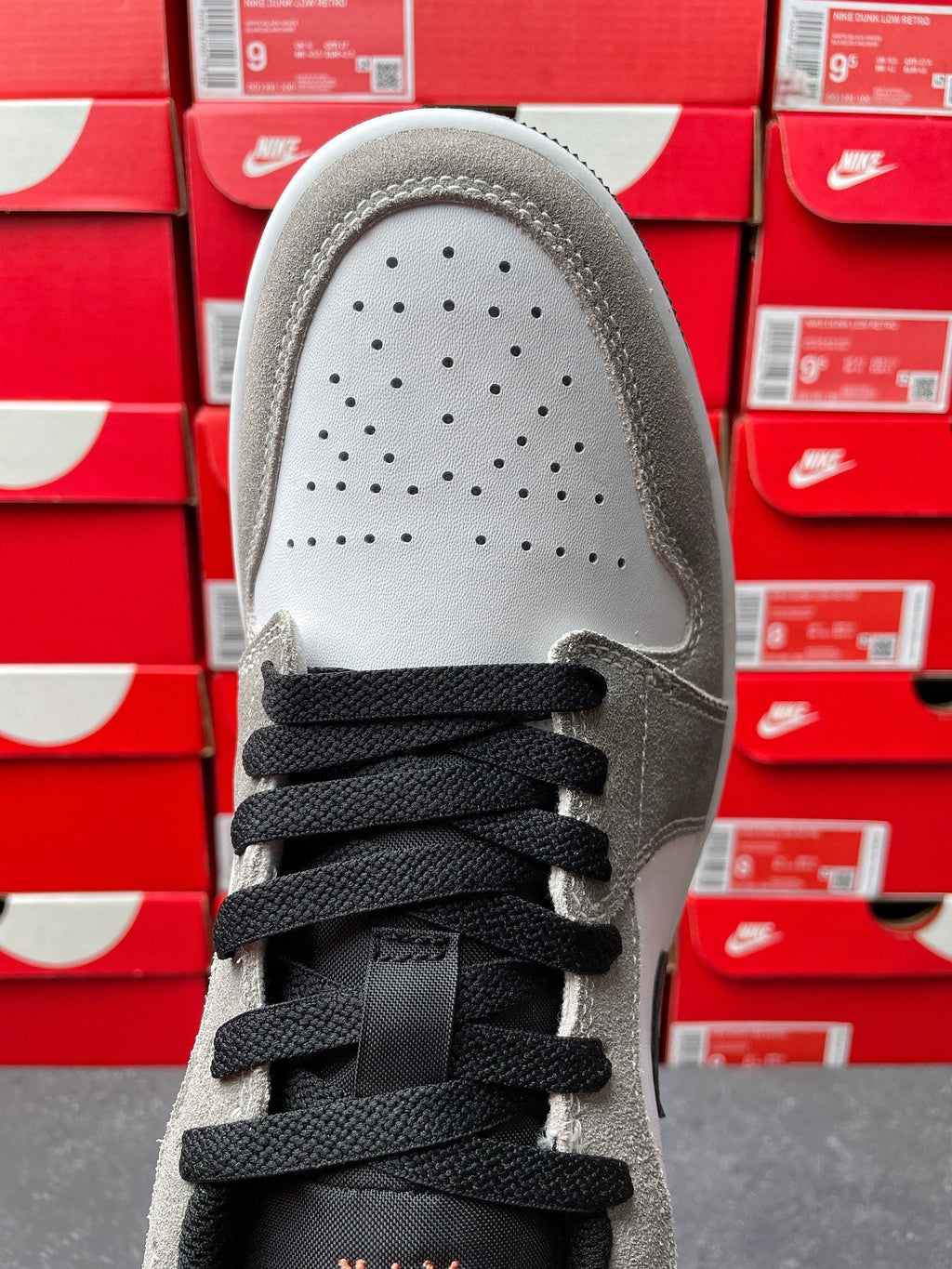 Low-top sneakers, top view of vamp with perforated toe box and black laces